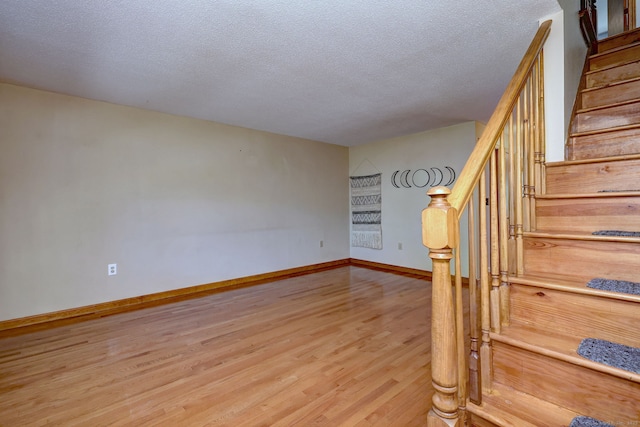 37 White Tail Ln Unit 37, Wallingford, CT 06492 - stairs featuring wood finished floors, baseboards, and a textured ceiling