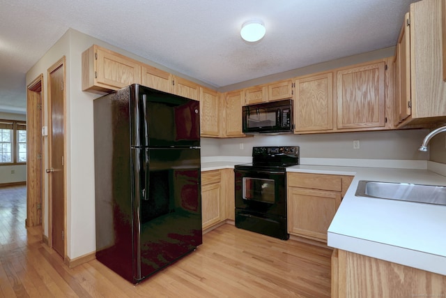 37 White Tail Ln Unit 37, Wallingford, CT 06492 - kitchen featuring black appliances, light brown cabinets, a sink, light wood-type flooring, and light countertops