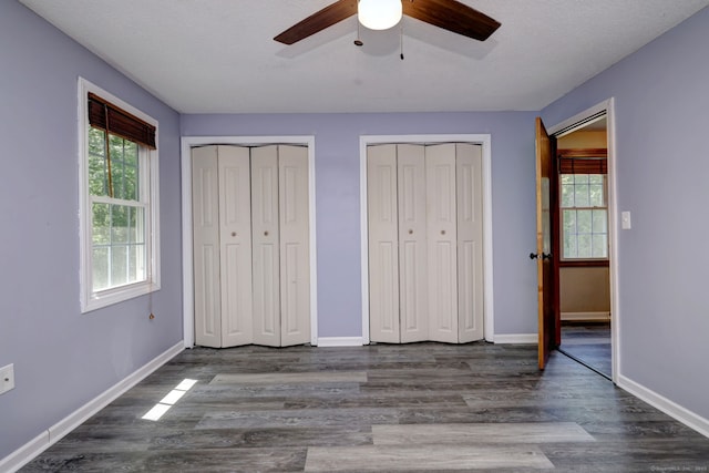 37 White Tail Ln Unit 37, Wallingford, CT 06492 - unfurnished bedroom featuring multiple closets, wood finished floors, and baseboards