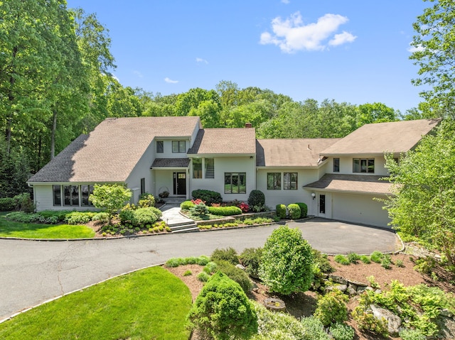 78 Pin Oak Ln, Wilton, CT 06897 - view of front of house featuring a chimney, driveway, and a patio