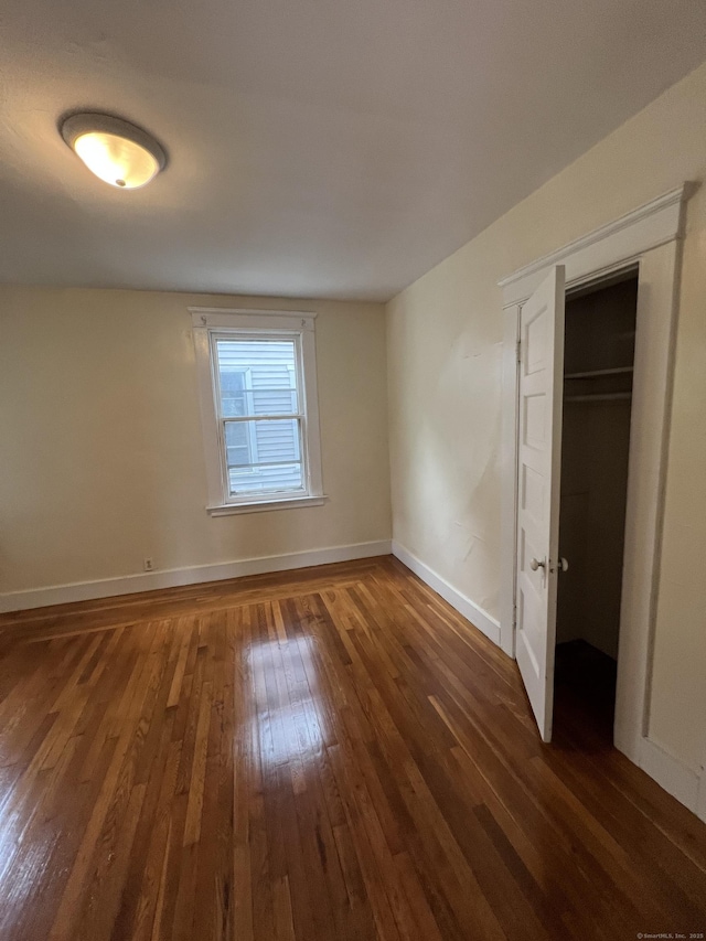 865 Elm St, New Haven, CT 06511 - unfurnished bedroom featuring wood-type flooring, baseboards, and a closet