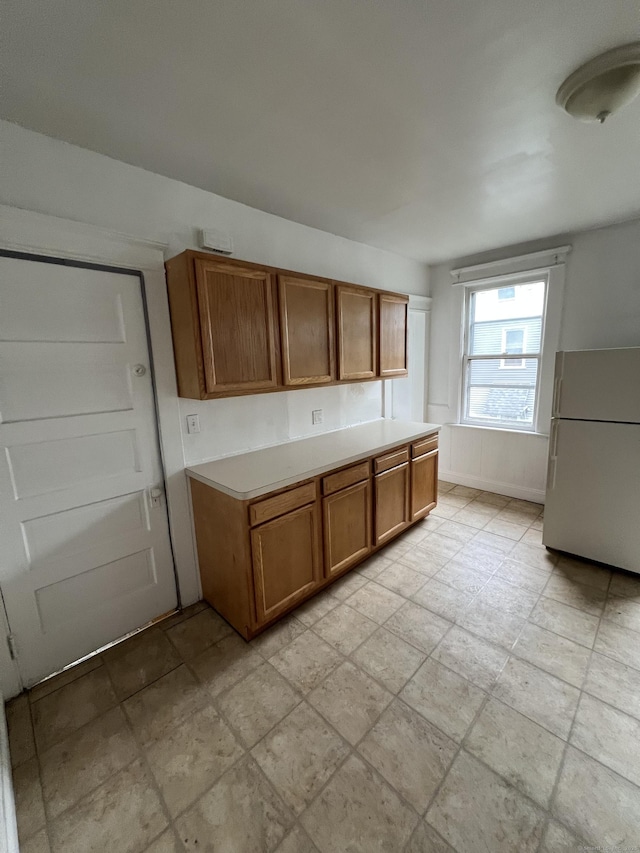865 Elm St, New Haven, CT 06511 - kitchen featuring freestanding refrigerator, brown cabinets, and light countertops
