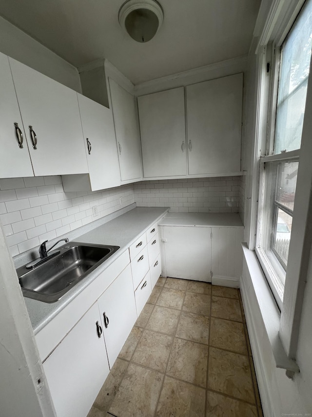 865 Elm St, New Haven, CT 06511 - kitchen featuring a sink, light countertops, backsplash, and white cabinetry