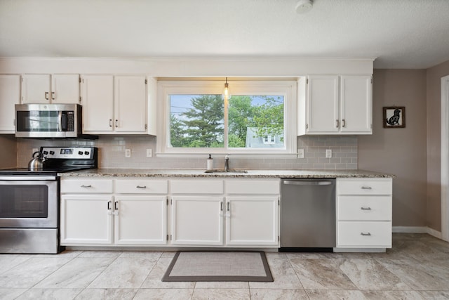 29 Carson Ave, Wethersfield, CT 06109 - kitchen featuring appliances with stainless steel finishes, a sink, white cabinets, and tasteful backsplash
