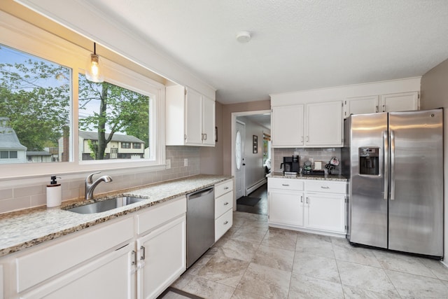 29 Carson Ave, Wethersfield, CT 06109 - kitchen featuring stainless steel appliances, a sink, decorative backsplash, white cabinetry, and light stone countertops