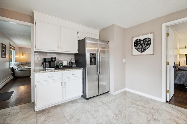 29 Carson Ave, Wethersfield, CT 06109 - kitchen featuring stainless steel refrigerator with ice dispenser, white cabinets, light stone countertops, tasteful backsplash, and baseboards