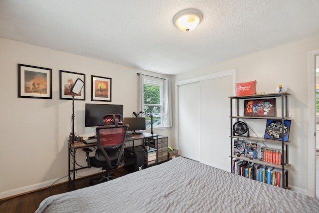 29 Carson Ave, Wethersfield, CT 06109 - bedroom with a closet, baseboards, a textured ceiling, a desk, and wood finished floors
