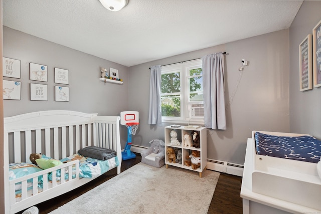 29 Carson Ave, Wethersfield, CT 06109 - bedroom featuring a baseboard heating unit, wood finished floors, a nursery area, a textured ceiling, and cooling unit