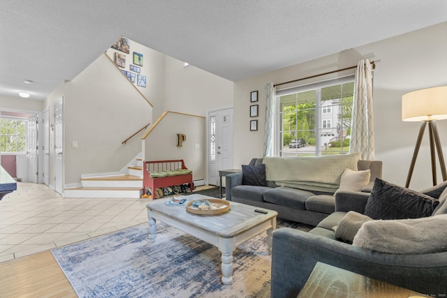 167 Santa Maria Dr, Torrington, CT 06790 - living room featuring stairway, wood finished floors, a textured ceiling, baseboards, and baseboard heating