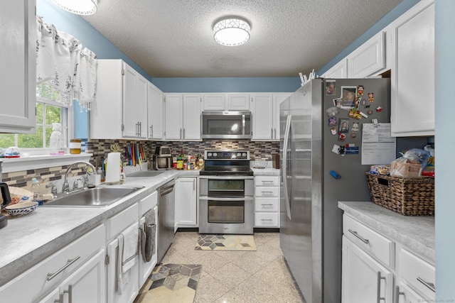 167 Santa Maria Dr, Torrington, CT 06790 - kitchen with appliances with stainless steel finishes, a sink, decorative backsplash, granite tiled floors, and a textured ceiling
