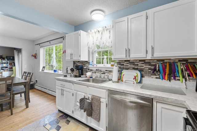 167 Santa Maria Dr, Torrington, CT 06790 - kitchen featuring stainless steel dishwasher, a baseboard radiator, light countertops, backsplash, and white cabinetry