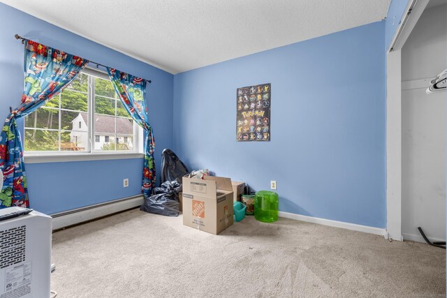 167 Santa Maria Dr, Torrington, CT 06790 - rec room with a baseboard heating unit, a textured ceiling, carpet flooring, and baseboards
