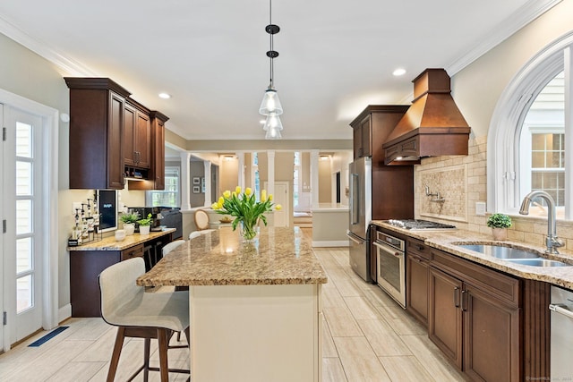 27 Chiltern St, Farmington, CT 06032 - kitchen featuring a sink, custom range hood, appliances with stainless steel finishes, a center island, and light stone counters