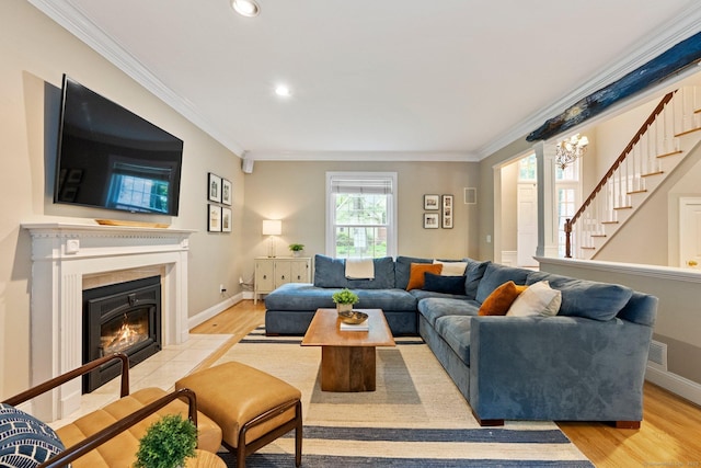 27 Chiltern St, Farmington, CT 06032 - living area with crown molding, stairs, recessed lighting, a tile fireplace, and light wood finished floors