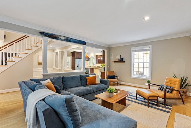 27 Chiltern St, Farmington, CT 06032 - living area with crown molding, decorative columns, light wood finished floors, baseboards, and stairway
