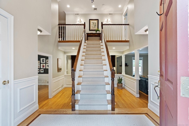 27 Chiltern St, Farmington, CT 06032 - foyer entrance with wood finished floors, decorative columns, ornamental molding, a decorative wall, and a high ceiling