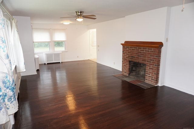 5 Chappell St, Chaplin, CT 06235 - unfurnished living room with wood finished floors, ceiling fan, radiator, and a brick fireplace