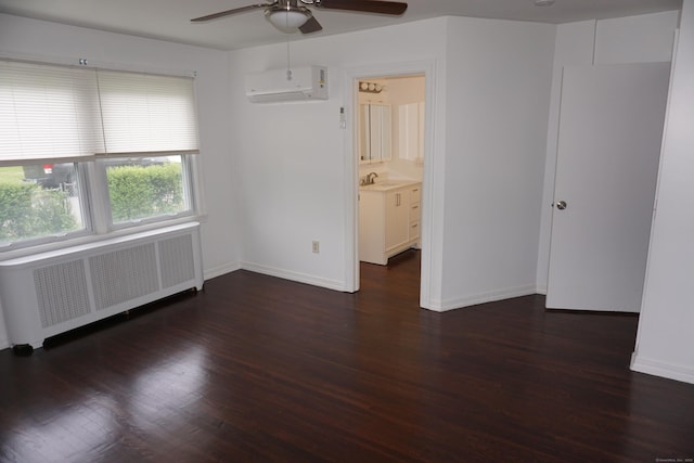 5 Chappell St, Chaplin, CT 06235 - spare room with radiator heating unit, an AC wall unit, a ceiling fan, wood finished floors, and baseboards