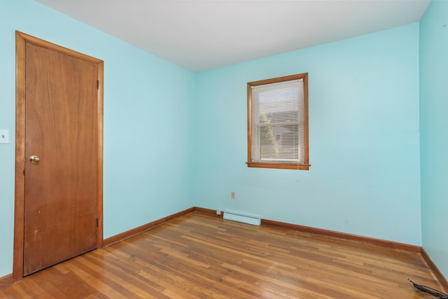 309 Marlborough Ter, Fairfield, CT 06825 - spare room with a baseboard heating unit, wood finished floors, and baseboards