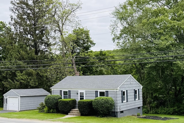 10 Bozrah St, Bozrah, CT 06334 - view of front facade with an outdoor structure, a front yard, a chimney, a garage, and a shingled roof