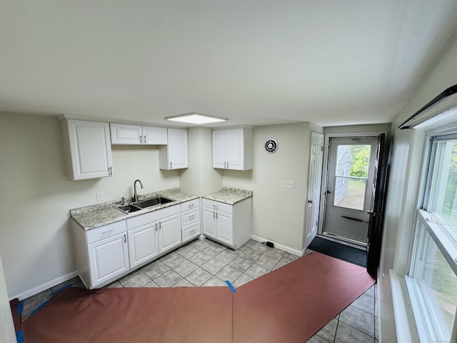 10 Bozrah St, Bozrah, CT 06334 - kitchen featuring a sink, baseboards, light tile patterned floors, and white cabinets