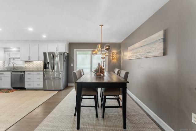 6 Meadow Dr, Waterford, CT 06385 - dining room with baseboards, a chandelier, and wood finished floors