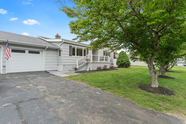 6 Meadow Dr, Waterford, CT 06385 - view of front of house with an attached garage, a front lawn, a chimney, and asphalt driveway