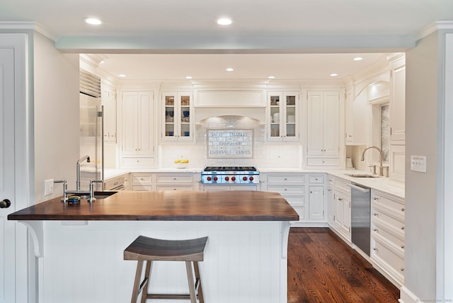 145 Seir Hill Rd, Wilton, CT 06897 - kitchen with a sink, wood counters, appliances with stainless steel finishes, a peninsula, and recessed lighting
