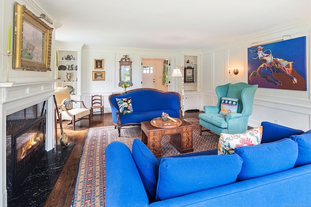 145 Seir Hill Rd, Wilton, CT 06897 - living room with a decorative wall, dark wood finished floors, ornamental molding, a high end fireplace, and built in features