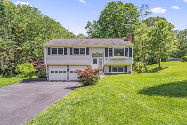 5 Settlers Ln, Newtown, CT 06482 - bi-level home featuring a chimney, asphalt driveway, a garage, a front yard, and view of scattered trees