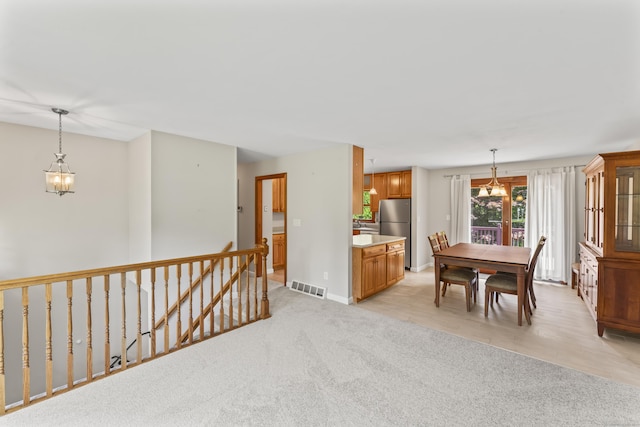 5 Settlers Ln, Newtown, CT 06482 - dining area with a chandelier, light colored carpet, and baseboards