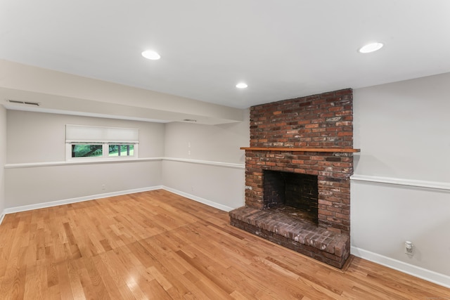 5 Settlers Ln, Newtown, CT 06482 - unfurnished living room featuring wood finished floors, a brick fireplace, baseboards, and recessed lighting