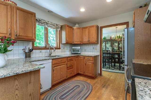 16 Botsford Rd, Kent, CT 06757 - kitchen featuring dishwasher, a sink, light wood finished floors, decorative backsplash, and light stone countertops
