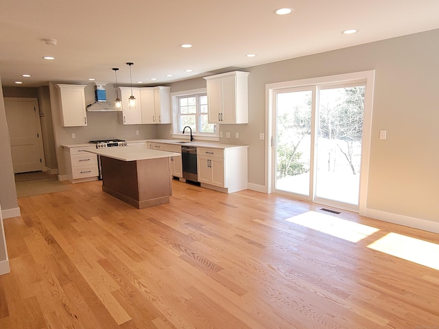 82 Ladd Rd, Tolland, CT 06084 - kitchen featuring appliances with stainless steel finishes, white cabinetry, wall chimney range hood, a kitchen island, and light countertops