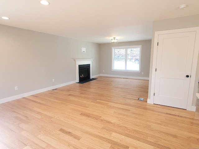 82 Ladd Rd, Tolland, CT 06084 - unfurnished living room featuring light wood-style floors, a fireplace with flush hearth, and recessed lighting