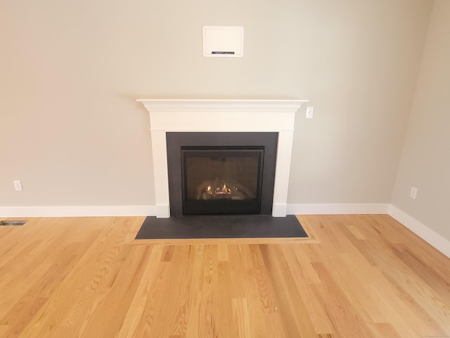 82 Ladd Rd, Tolland, CT 06084 - detailed view of wood finished floors and a fireplace with flush hearth