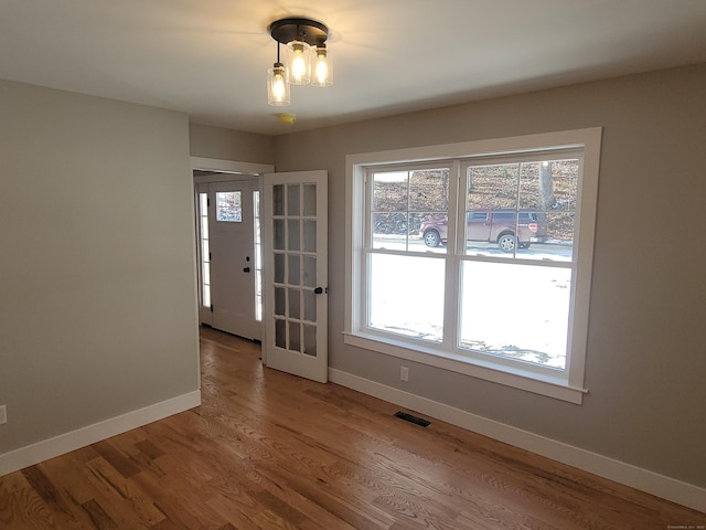 82 Ladd Rd, Tolland, CT 06084 - empty room with plenty of natural light and wood finished floors