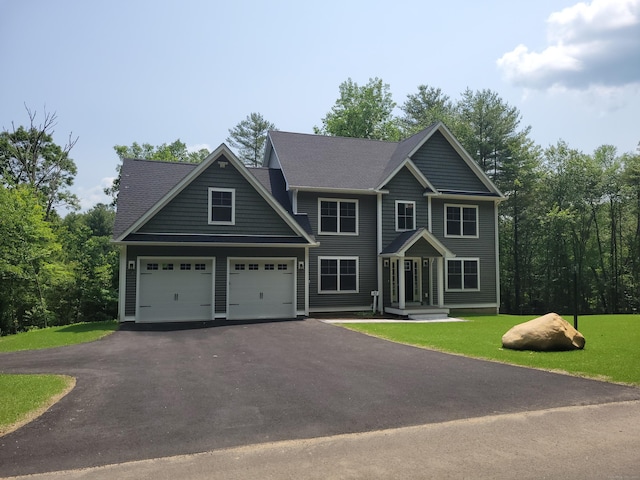 82 Ladd Rd, Tolland, CT 06084 - colonial house with asphalt driveway, a garage, and a front yard