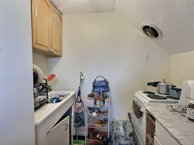 1 N Taylor Ave, Norwalk, CT 06854 - kitchen featuring white electric range, light brown cabinetry, a textured ceiling, and vaulted ceiling