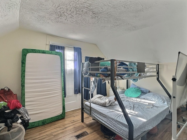1 N Taylor Ave, Norwalk, CT 06854 - bedroom with lofted ceiling, wood finished floors, and a textured ceiling