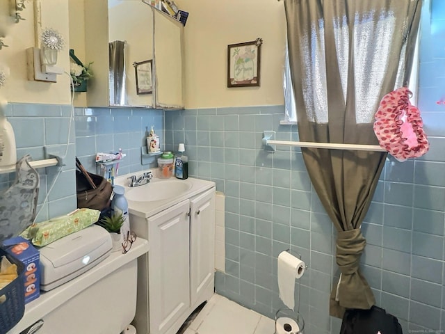 1 N Taylor Ave, Norwalk, CT 06854 - half bathroom with tile walls, vanity, tile patterned floors, a wainscoted wall, and toilet