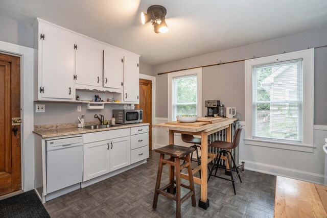 5 Seymour Ave, West Hartford, CT 06119 - kitchen featuring dishwasher, a sink, stainless steel microwave, light countertops, and white cabinetry