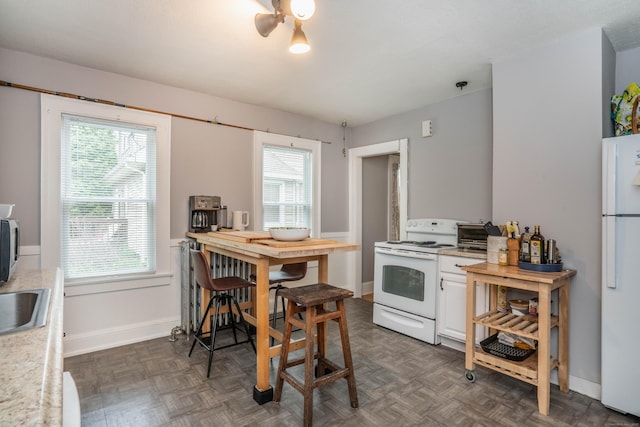 5 Seymour Ave, West Hartford, CT 06119 - kitchen with white appliances, light countertops, healthy amount of natural light, and a sink