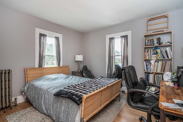 5 Seymour Ave, West Hartford, CT 06119 - bedroom with radiator heating unit, wood-type flooring, an office area, and baseboards
