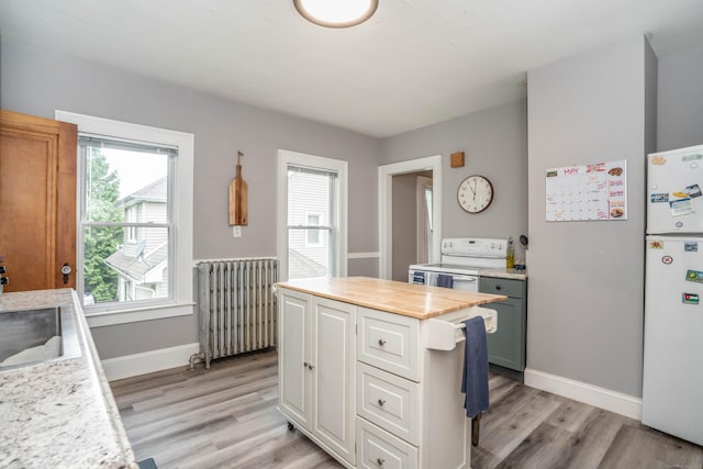 5 Seymour Ave, West Hartford, CT 06119 - kitchen featuring radiator, white appliances, light wood-style flooring, baseboards, and white cabinets