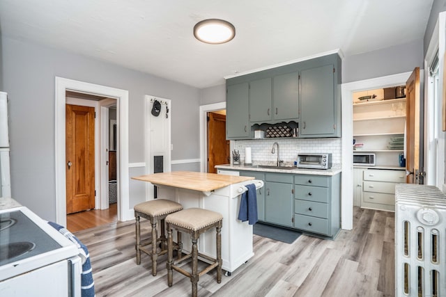 5 Seymour Ave, West Hartford, CT 06119 - kitchen with a sink, light countertops, radiator, and light wood-style flooring