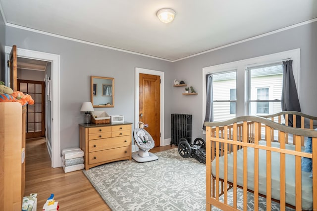 5 Seymour Ave, West Hartford, CT 06119 - bedroom featuring crown molding, light wood finished floors, and a crib