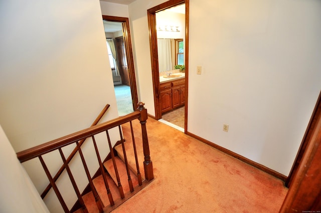 24 Jennifer Rd, Bristol, CT 06010 - hallway featuring a sink, light carpet, an upstairs landing, and baseboards