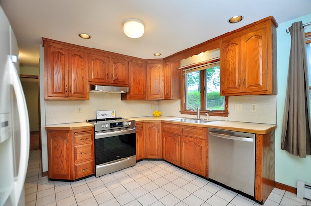24 Jennifer Rd, Bristol, CT 06010 - kitchen featuring appliances with stainless steel finishes, under cabinet range hood, a sink, light countertops, and brown cabinets