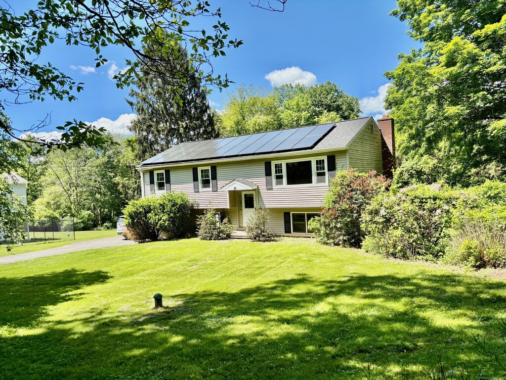20 Old Hawleyville Rd, Bethel, CT 06801 - raised ranch with solar panels, a chimney, and a front lawn